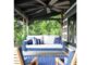 How Can a Porch Bed, Pops of Colors, Rugs, and Ambient Lighting All Spruce Up Your Outdoor Living Space